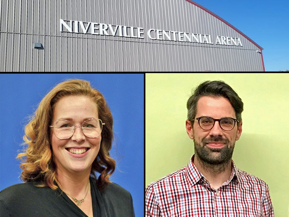 Niverville Town Councillor Meghan Beasant (left) and the Director of Recreation & Wellness for the town, Warren Britton (right), working together on the new Lending Library inside the Niverville Centennial Arena.